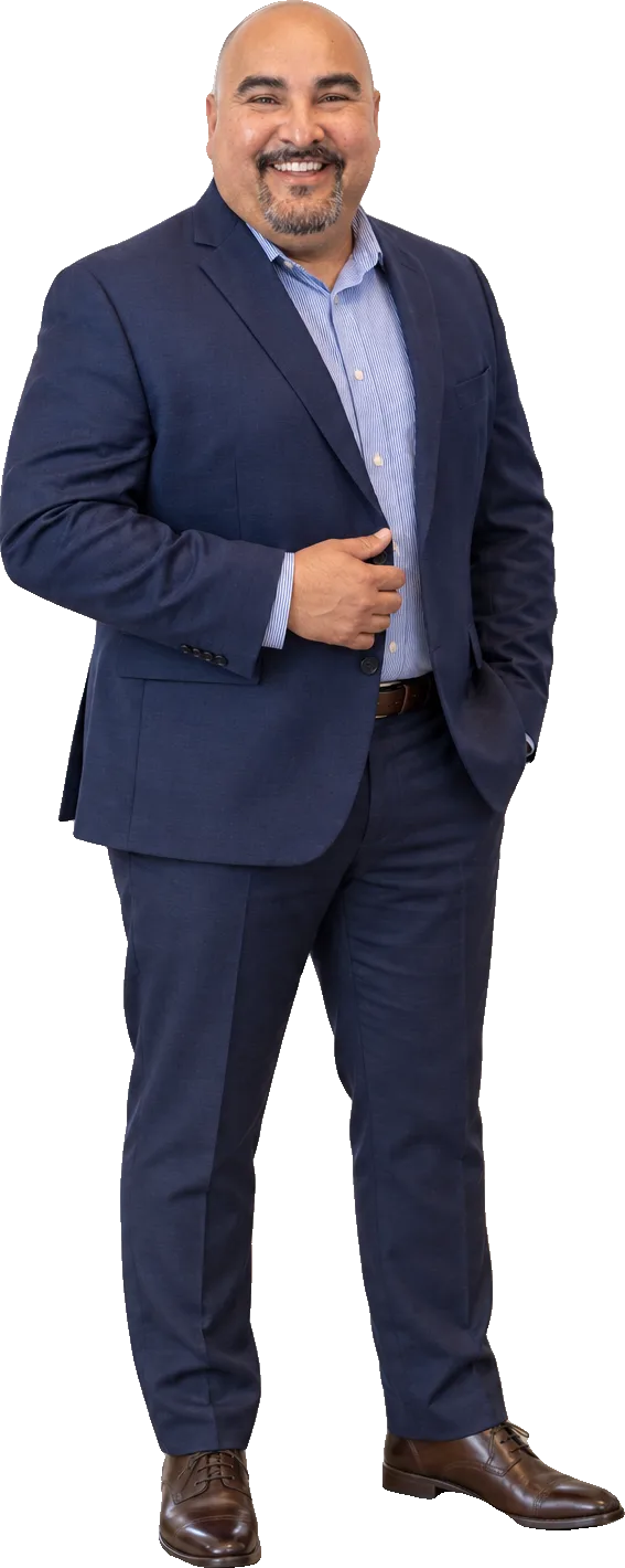 Alan Bermudez, REALTOR®, standing in a navy suit and smiling